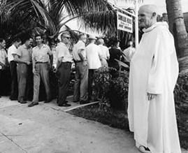 Camillus House founder Brother Mathias in 1960 with early Cuban exiles.
